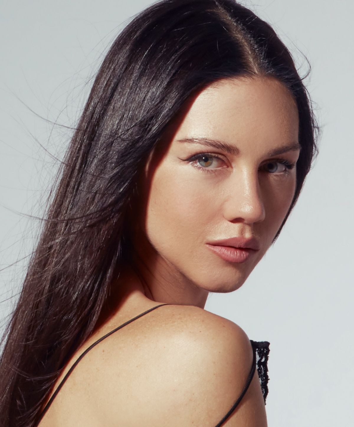 Portrait of a woman with long black hair.