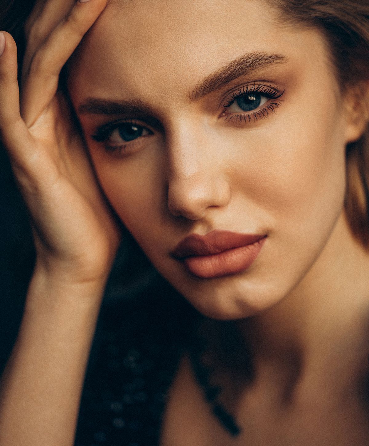 Close-up portrait of a woman with soft features.