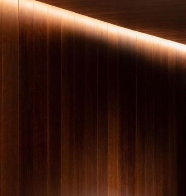 Warm wood paneling with soft lighting effect.